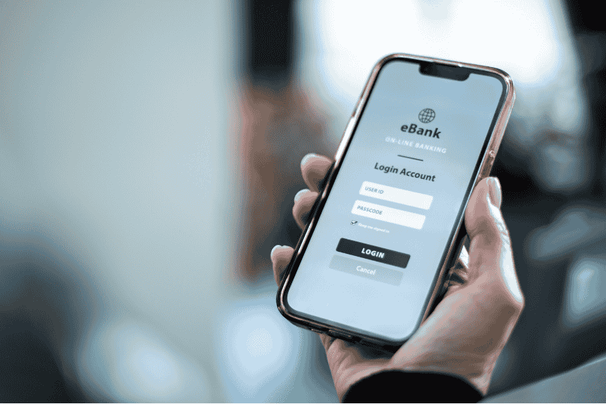 Using a mobile banking app on a smartphone, showing how digital banking features impact bank selection in the US