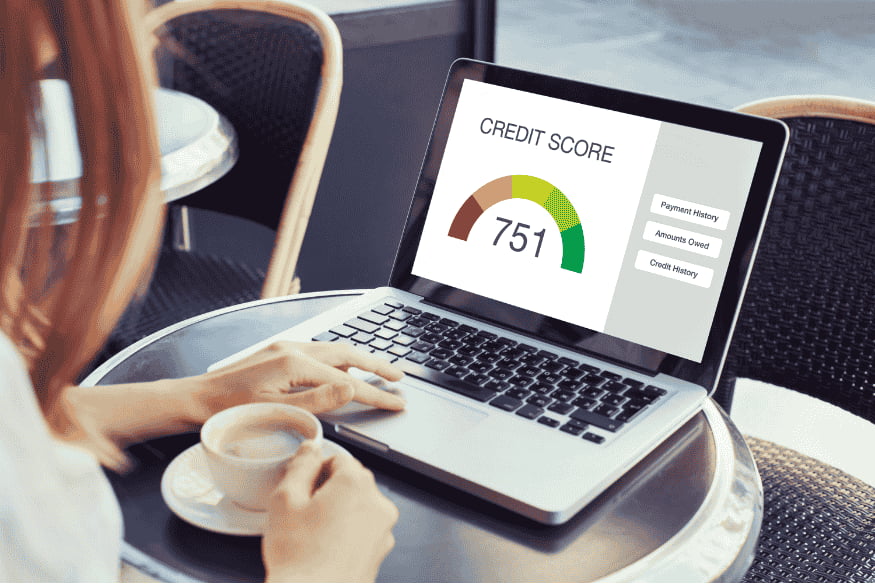 Checking credit score online on a laptop as part of building credit history in the United States